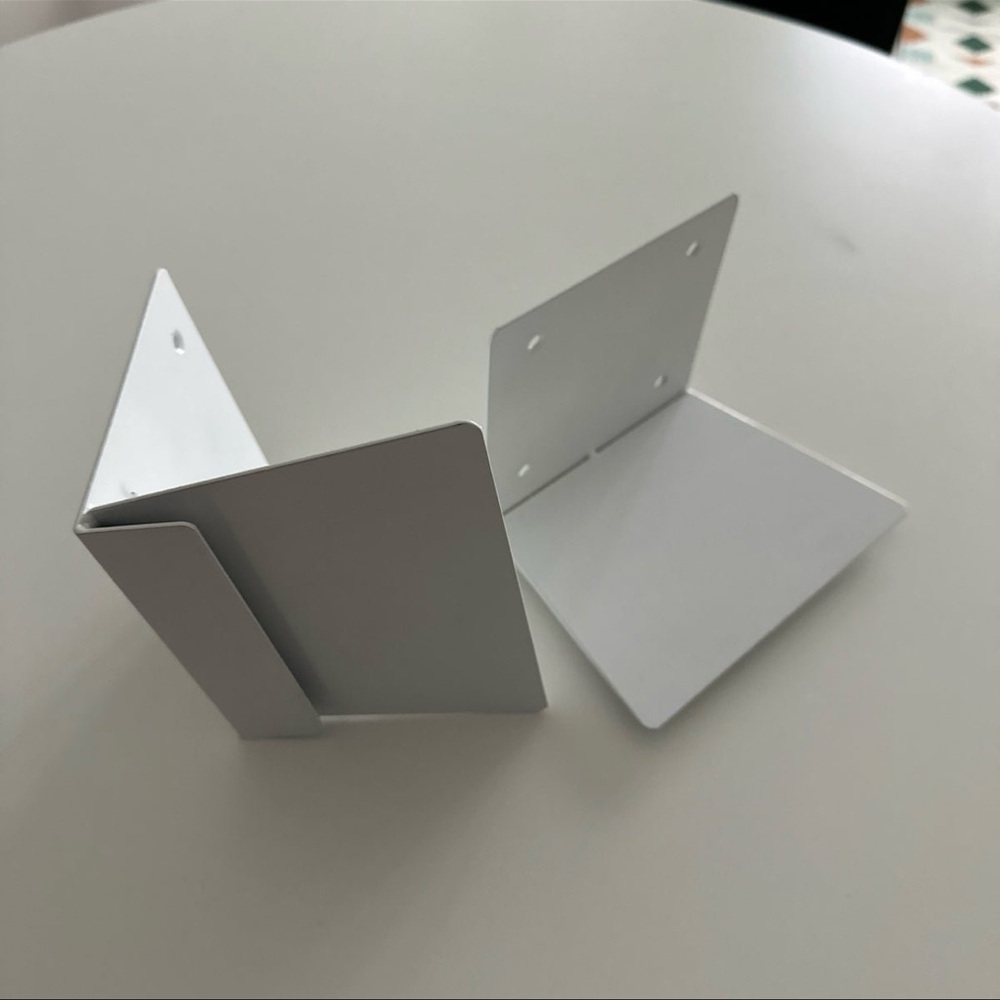 Two white floating bookshelves